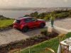 Drone shot of the 2026 Mazda CX-5 from the rear, parked in a driveway with the ocean in the background