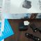 A small, black GoPro Hero 4K action camera resting on a table, its compact size and potential for discreet use.