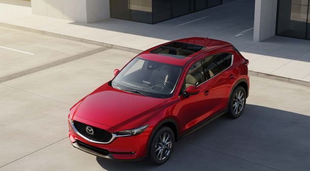 Image of the new 2026 mazda cx 5 in front of a building